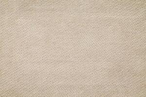 Natural Linen Material Textile Canvas Fabric Texture Background Close-up Detail of Fabric Natural Color Hemp Material Pattern Design Wallpaper. Can be Used as Background or For Graphic Design photo