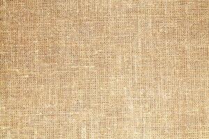 Natural Linen Material Textile Canvas Fabric Texture Background Close-up Detail of Fabric Natural Color Hemp Material Pattern Design Wallpaper. Can be Used as Background or For Graphic Design photo