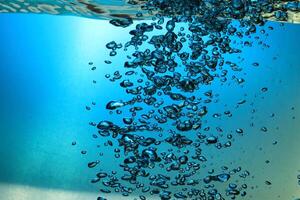 Fresh Water With Underwater Bubbles Texture on a Blue Background Close-up Abstract Liquid Bubbles Aqua Design Wallpaper photo