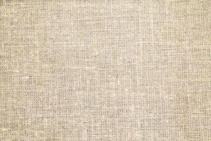 Natural Linen Material Textile Canvas Fabric Texture Background Close-up Detail of Fabric Natural Color Hemp Material Pattern Design Wallpaper. Can be Used as Background or For Graphic Design photo
