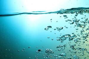Fresh Water With Underwater Bubbles Texture on a Blue Background Close-up Abstract Liquid Bubbles Aqua Design Wallpaper photo