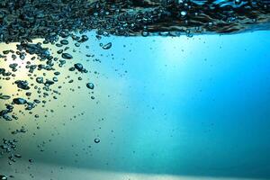 Fresh Water With Underwater Bubbles Texture on a Blue Background Close-up Abstract Liquid Bubbles Aqua Design Wallpaper photo