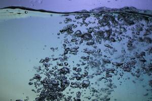 Fresh Water With Underwater Bubbles Texture on a Blue Background Close-up Abstract Liquid Bubbles Aqua Design Wallpaper photo