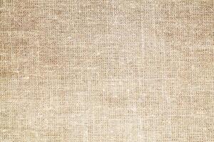 Natural Linen Material Textile Canvas Fabric Texture Background Close-up Detail of Fabric Natural Color Hemp Material Pattern Design Wallpaper. Can be Used as Background or For Graphic Design photo