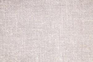 Natural Linen Material Textile Canvas Fabric Texture Background Close-up Detail of Fabric Natural Color Hemp Material Pattern Design Wallpaper. Can be Used as Background or For Graphic Design photo