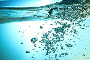 Fresh Water With Underwater Bubbles Texture on a Blue Background Close-up Abstract Liquid Bubbles Aqua Design Wallpaper photo