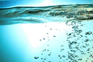 Fresh Water With Underwater Bubbles Texture on a Blue Background Close-up Abstract Liquid Bubbles Aqua Design Wallpaper photo