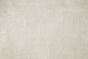 Natural Linen Material Textile Canvas Fabric Texture Background Close-up Detail of Fabric Natural Color Hemp Material Pattern Design Wallpaper. Can be Used as Background or For Graphic Design photo