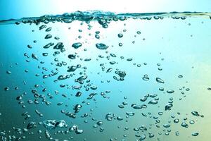 Fresh Water With Underwater Bubbles Texture on a Blue Background Close-up Abstract Liquid Bubbles Aqua Design Wallpaper photo