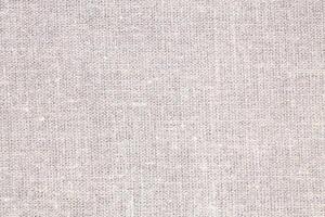 Natural Linen Material Textile Canvas Fabric Texture Background Close-up Detail of Fabric Natural Color Hemp Material Pattern Design Wallpaper. Can be Used as Background or For Graphic Design photo