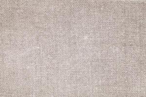 Natural Linen Material Textile Canvas Fabric Texture Background Close-up Detail of Fabric Natural Color Hemp Material Pattern Design Wallpaper. Can be Used as Background or For Graphic Design photo