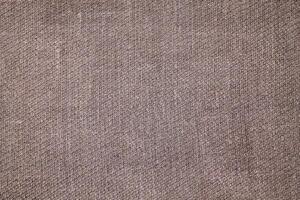 Natural Linen Material Textile Canvas Fabric Texture Background Close-up Detail of Fabric Natural Color Hemp Material Pattern Design Wallpaper. Can be Used as Background or For Graphic Design photo