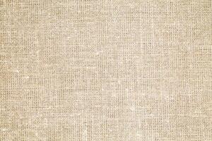 Natural Linen Material Textile Canvas Fabric Texture Background Close-up Detail of Fabric Natural Color Hemp Material Pattern Design Wallpaper. Can be Used as Background or For Graphic Design photo