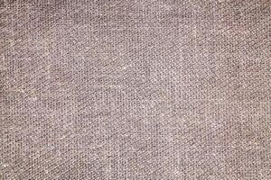 Natural Linen Material Textile Canvas Fabric Texture Background Close-up Detail of Fabric Natural Color Hemp Material Pattern Design Wallpaper. Can be Used as Background or For Graphic Design photo