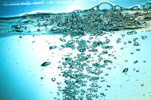 Fresh Water With Underwater Bubbles Texture on a Blue Background Close-up Abstract Liquid Bubbles Aqua Design Wallpaper photo