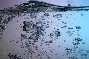 Fresh Water With Underwater Bubbles Texture on a Blue Background Close-up Abstract Liquid Bubbles Aqua Design Wallpaper photo