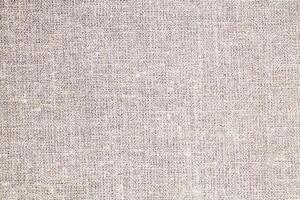 Natural Linen Material Textile Canvas Fabric Texture Background Close-up Detail of Fabric Natural Color Hemp Material Pattern Design Wallpaper. Can be Used as Background or For Graphic Design photo