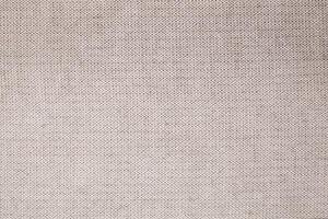 Natural Linen Material Textile Canvas Fabric Texture Background Close-up Detail of Fabric Natural Color Hemp Material Pattern Design Wallpaper. Can be Used as Background or For Graphic Design photo