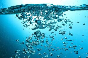 Fresh Water With Underwater Bubbles Texture on a Blue Background Close-up Abstract Liquid Bubbles Aqua Design Wallpaper photo