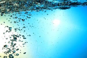 Fresh Water With Underwater Bubbles Texture on a Blue Background Close-up Abstract Liquid Bubbles Aqua Design Wallpaper photo