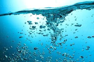 Fresh Water With Underwater Bubbles Texture on a Blue Background Close-up Abstract Liquid Bubbles Aqua Design Wallpaper photo