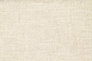 Natural Linen Material Textile Canvas Fabric Texture Background Close-up Detail of Fabric Natural Color Hemp Material Pattern Design Wallpaper. Can be Used as Background or For Graphic Design photo