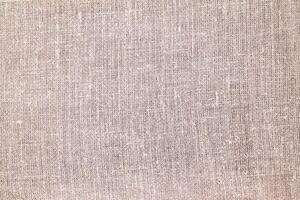 Natural Linen Material Textile Canvas Fabric Texture Background Close-up Detail of Fabric Natural Color Hemp Material Pattern Design Wallpaper. Can be Used as Background or For Graphic Design photo