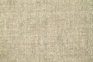 Natural Linen Material Textile Canvas Fabric Texture Background Close-up Detail of Fabric Natural Color Hemp Material Pattern Design Wallpaper. Can be Used as Background or For Graphic Design photo