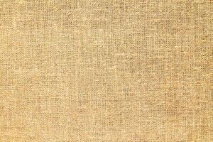Natural Linen Material Textile Canvas Fabric Texture Background Close-up Detail of Fabric Natural Color Hemp Material Pattern Design Wallpaper. Can be Used as Background or For Graphic Design photo