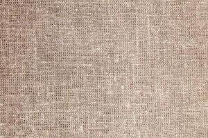 Natural Linen Material Textile Canvas Fabric Texture Background Close-up Detail of Fabric Natural Color Hemp Material Pattern Design Wallpaper. Can be Used as Background or For Graphic Design photo