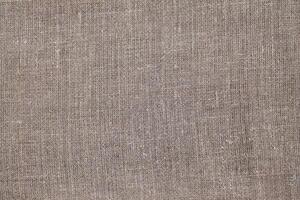 Natural Linen Material Textile Canvas Fabric Texture Background Close-up Detail of Fabric Natural Color Hemp Material Pattern Design Wallpaper. Can be Used as Background or For Graphic Design photo