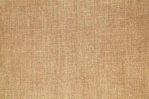 Natural Linen Material Textile Canvas Fabric Texture Background Close-up Detail of Fabric Natural Color Hemp Material Pattern Design Wallpaper. Can be Used as Background or For Graphic Design photo