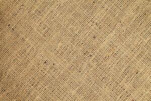 Natural Linen Material Textile Canvas Fabric Texture Background Close-up Detail of Fabric Natural Color Hemp Material Pattern Design Wallpaper. Can be Used as Background or For Graphic Design photo