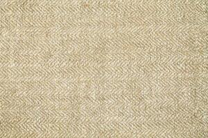 Natural Linen Material Textile Canvas Fabric Texture Background Close-up Detail of Fabric Natural Color Hemp Material Pattern Design Wallpaper. Can be Used as Background or For Graphic Design photo