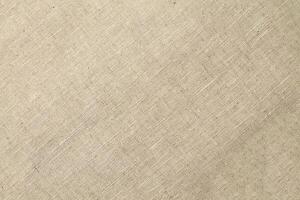 Natural Linen Material Textile Canvas Fabric Texture Background Close-up Detail of Fabric Natural Color Hemp Material Pattern Design Wallpaper. Can be Used as Background or For Graphic Design photo