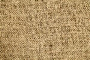 Natural Linen Material Textile Canvas Fabric Texture Background Close-up Detail of Fabric Natural Color Hemp Material Pattern Design Wallpaper. Can be Used as Background or For Graphic Design photo