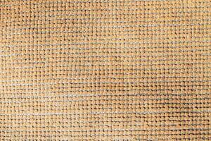Natural Linen Material Textile Canvas Fabric Texture Background Close-up Detail of Fabric Natural Color Hemp Material Pattern Design Wallpaper. Can be Used as Background or For Graphic Design photo