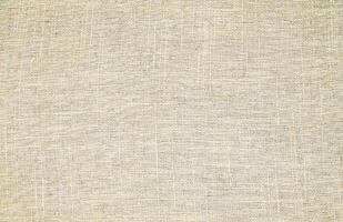 Natural Linen Material Textile Canvas Fabric Texture Background Close-up Detail of Fabric Natural Color Hemp Material Pattern Design Wallpaper. Can be Used as Background or For Graphic Design photo