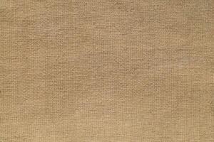 Natural Linen Material Textile Canvas Fabric Texture Background Close-up Detail of Fabric Natural Color Hemp Material Pattern Design Wallpaper. Can be Used as Background or For Graphic Design photo