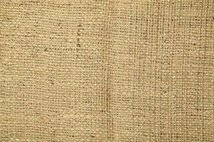 Natural Linen Material Textile Canvas Fabric Texture Background Close-up Detail of Fabric Natural Color Hemp Material Pattern Design Wallpaper. Can be Used as Background or For Graphic Design photo
