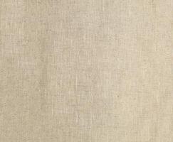 Natural Linen Material Textile Canvas Fabric Texture Background Close-up Detail of Fabric Natural Color Hemp Material Pattern Design Wallpaper. Can be Used as Background or For Graphic Design photo