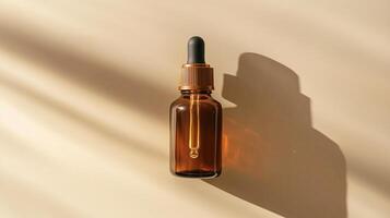 A brown glass bottle with an amber dropper for skin care on beige background. photo