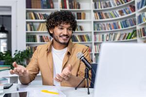 An engaging podcaster in a casual setting, discussing topics live with a microphone and laptop in front of bookshelves. photo