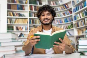 A diligent student engages in intense study at a library, with stacks of books around. The scene depicts preparation for university exams, conveying dedication and the pursuit of knowledge at an academic campus. photo