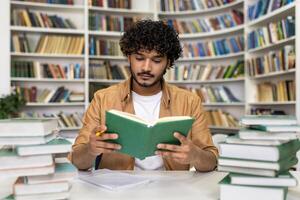 A focused graduate student immerses in exam preparation, reading intently amongst piles of books in a university library with an atmosphere of academic pursuit. photo