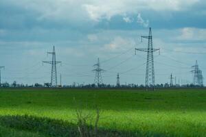 High voltage towers with sky background. Power line support with wires for electricity transmission. High voltage grid tower with wire cable at distribution station. Energy industry, energy saving photo