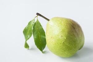 a pear with a leaf on it is on a white background photo