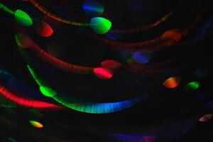 Abstract black background with bokeh of different colors. photo