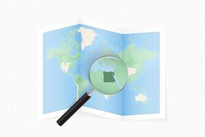 Enlarge Egypt with a magnifying glass on a folded map of the world. vector