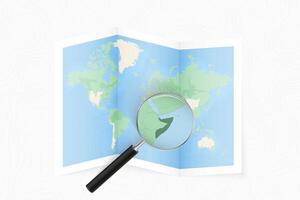Enlarge Somalia with a magnifying glass on a folded map of the world. vector